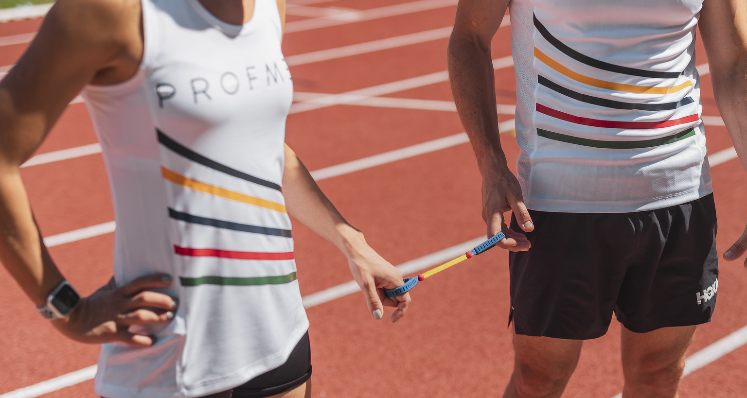 A photo of Louzanne and her guide on the track holding the tether between them.